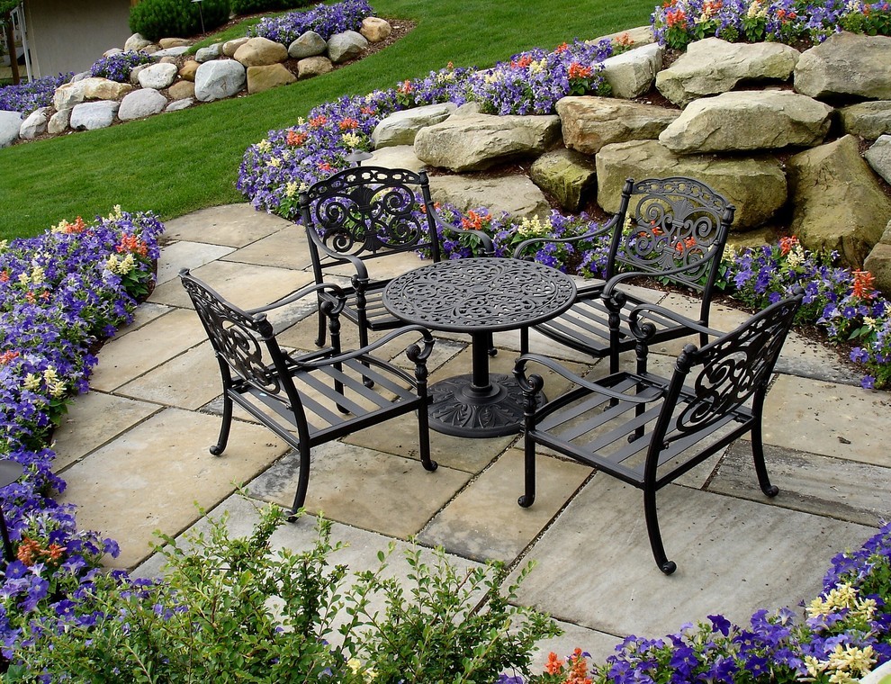 Traditional Ornate Outdoor Seating Nook with Stone Paving & Flowers