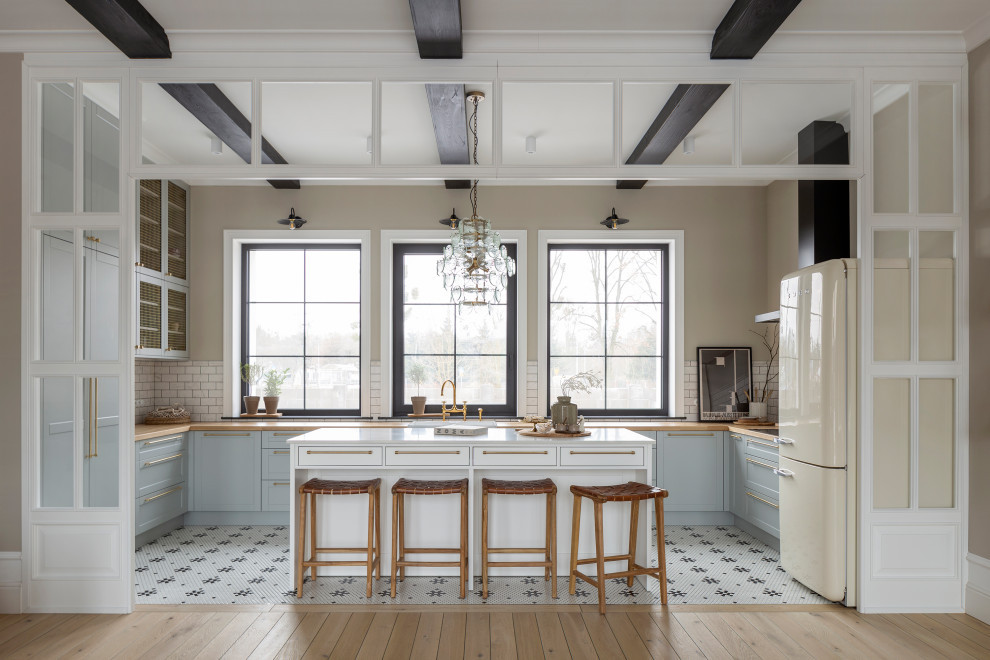 Sunlit Farmhouse Kitchen with Dark Ceiling Beams & Central Island
