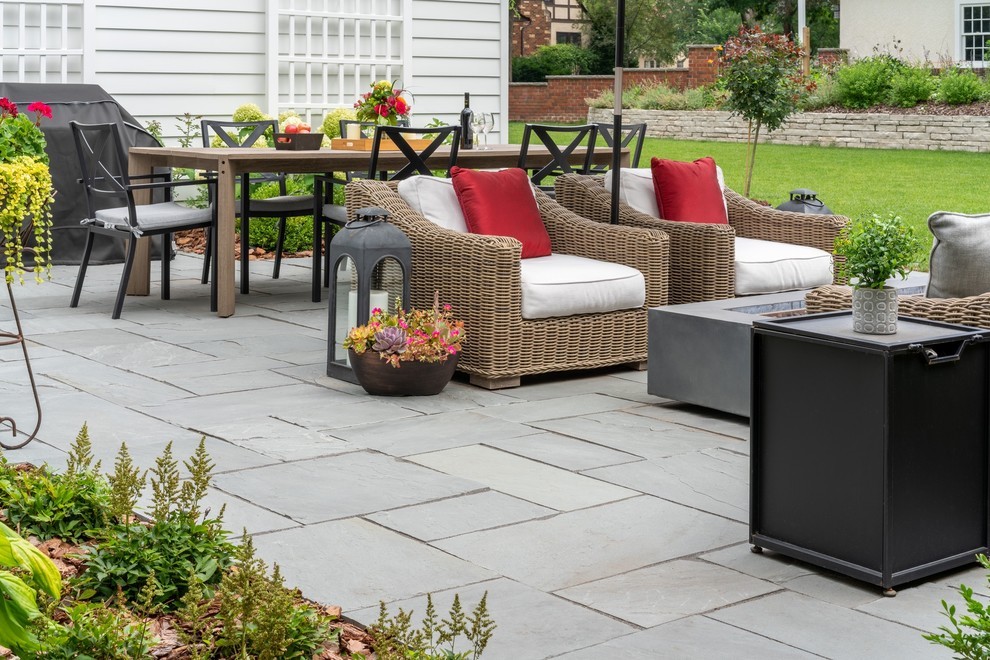 Sunny Contemporary Outdoor Oasis with Woven Seating & Sleek Stone Paving