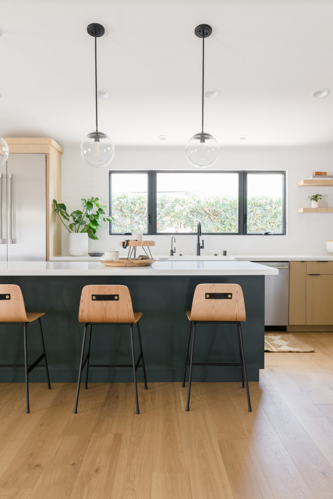 Sunlit Modern Kitchen with Lightwood Island & Pendant Seating