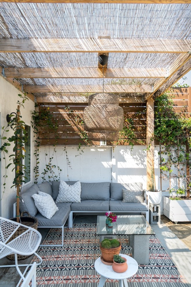 Sunlit Modern Rustic Patio with Woven Canopy & Plush Seating